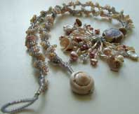 Lynn Davy Beading - Beading Gallery - Photography by Joanna Bury. Dawn Strandline  A peyote spiral in muted colors complements the lampwork focal by Vicki Honeywill. An abundance of seashell curls emphasizes the seaside theme!  click on thumbnail to see larger image